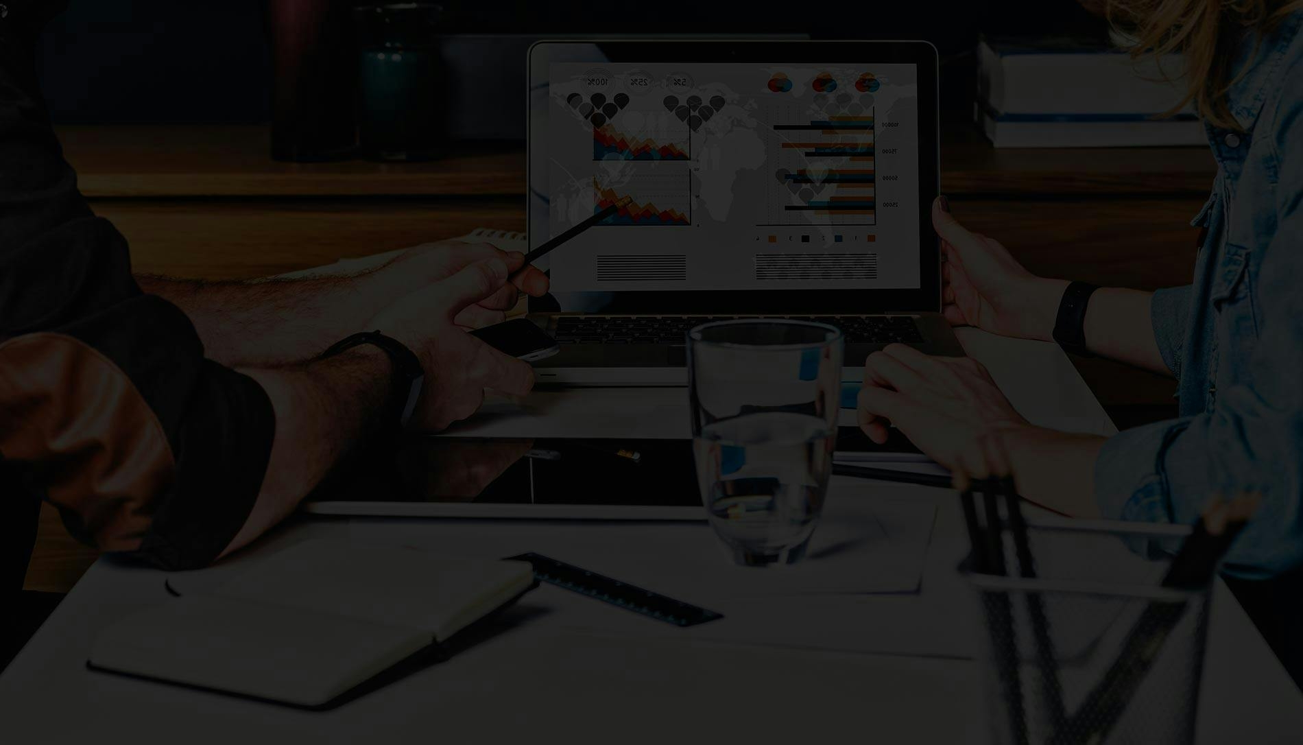 Imagen de dos personas trabajando con una laptop en un plan de marketing efectivo para su empresa.
